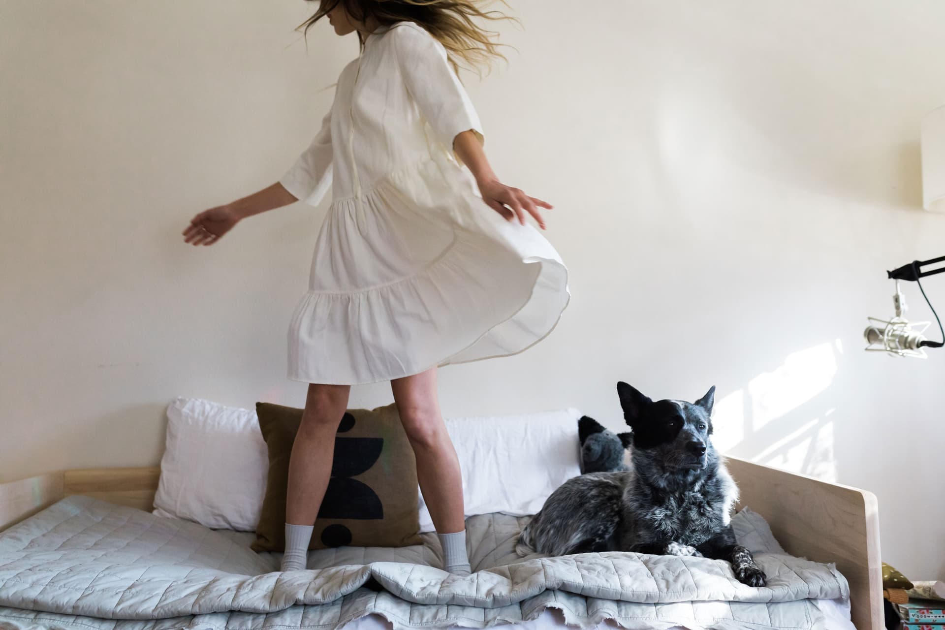 Adriene Mishler stands next to her dog