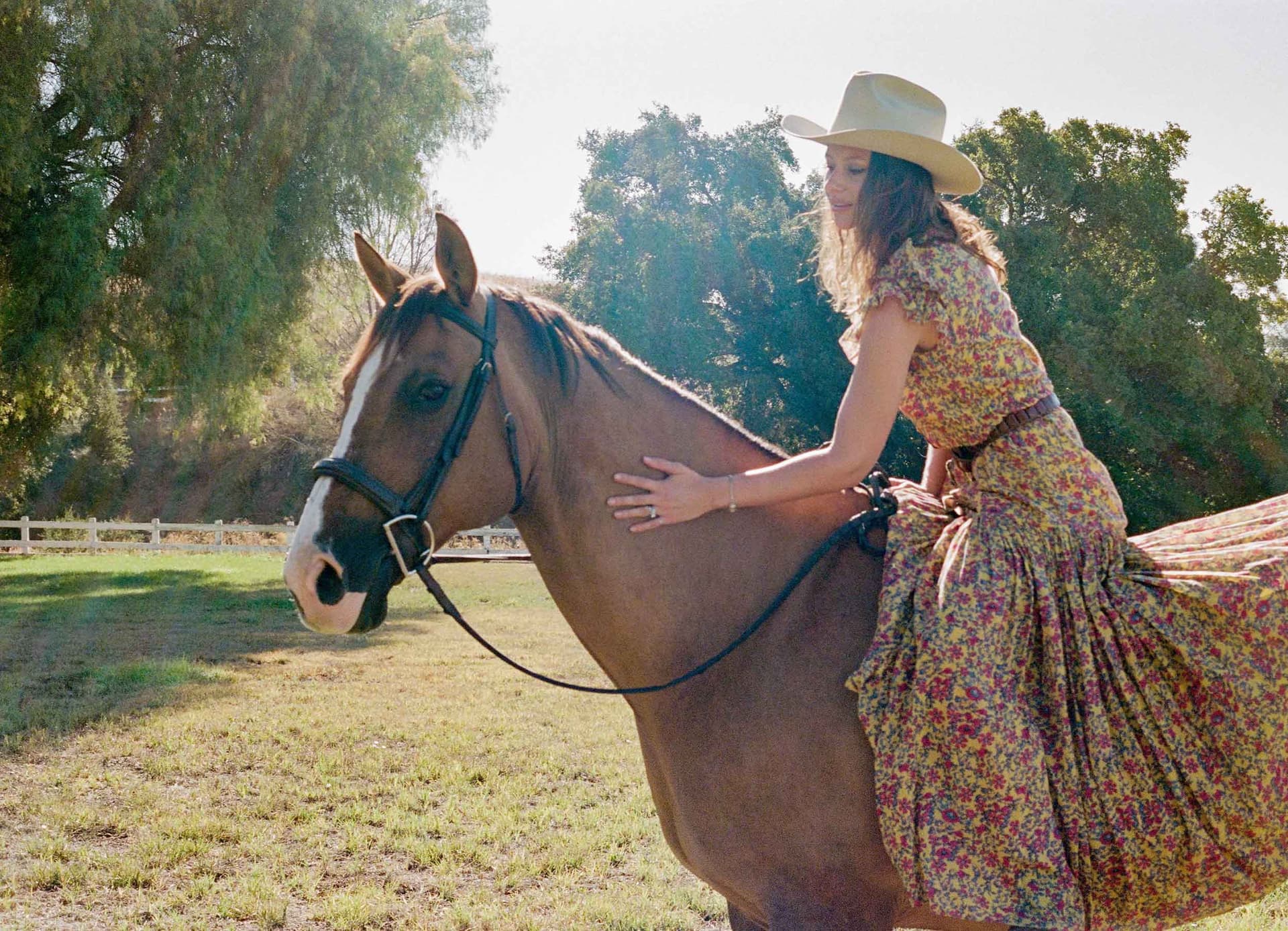Aly Michalka wears a dress and hat while riding her horse