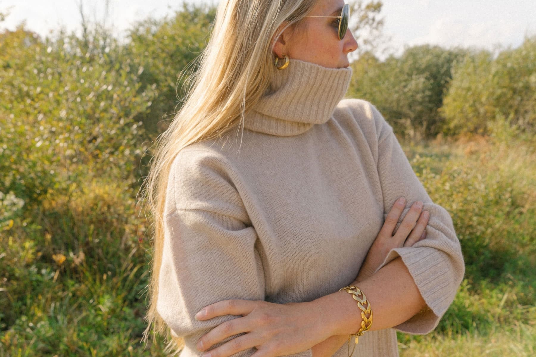 Colleen Herman wears a brown sweater and stands outside
