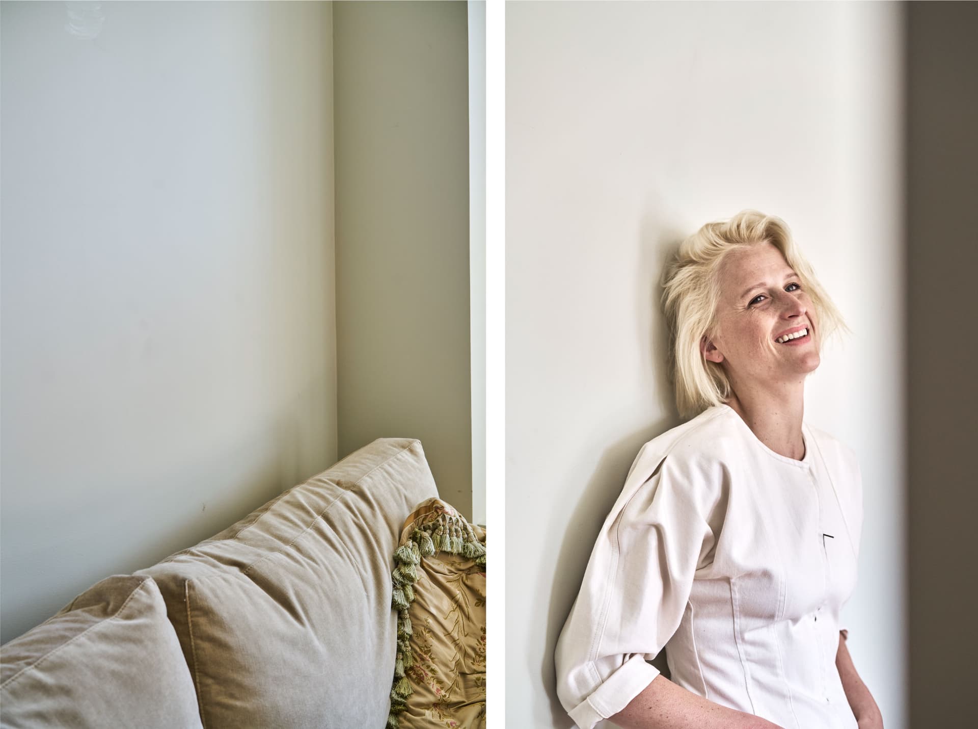 Mamie Gummer stands in white in front of a wall