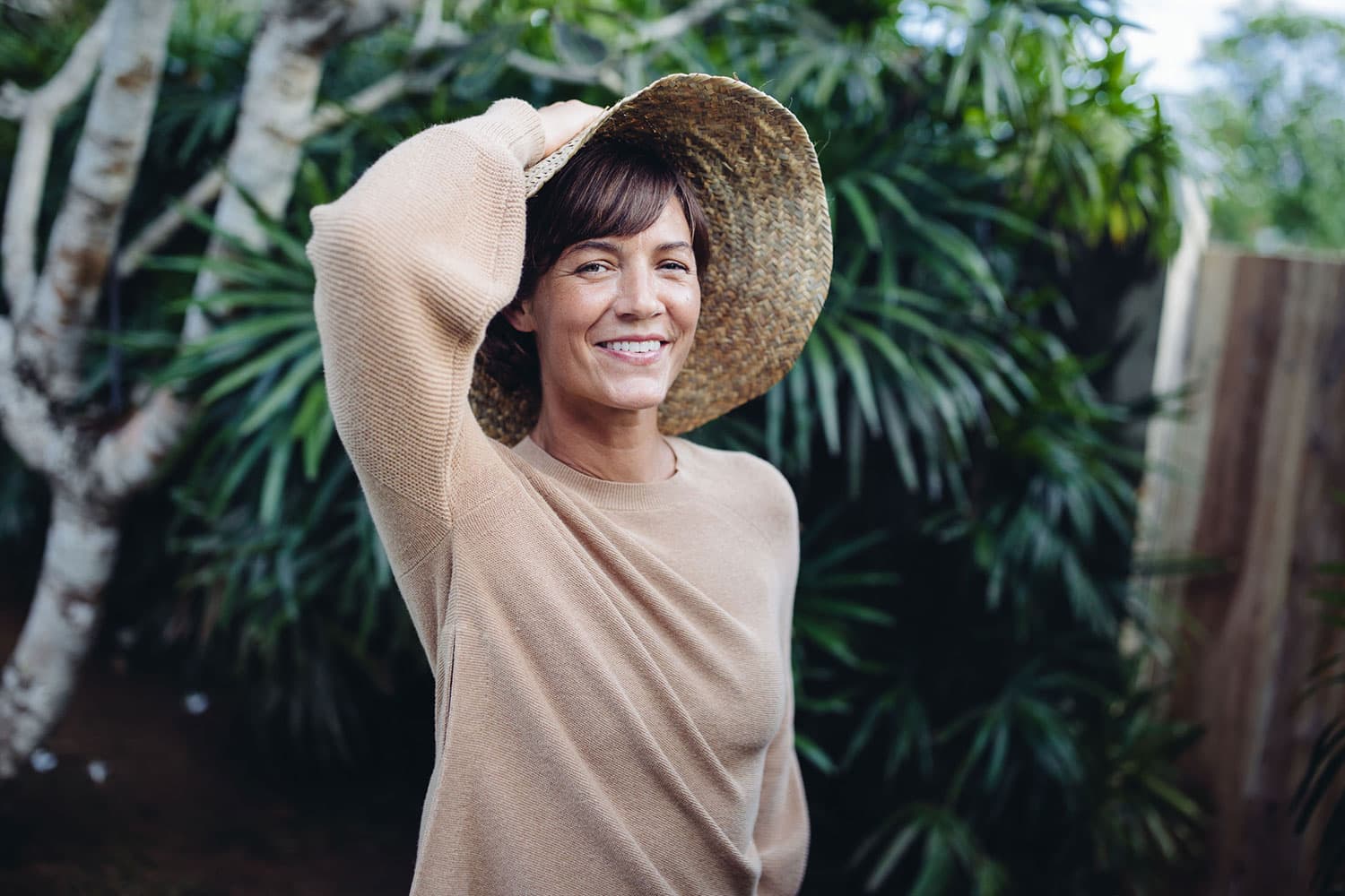Taryn Elledge-Penner wears a brown shirt and hat while standing outside.