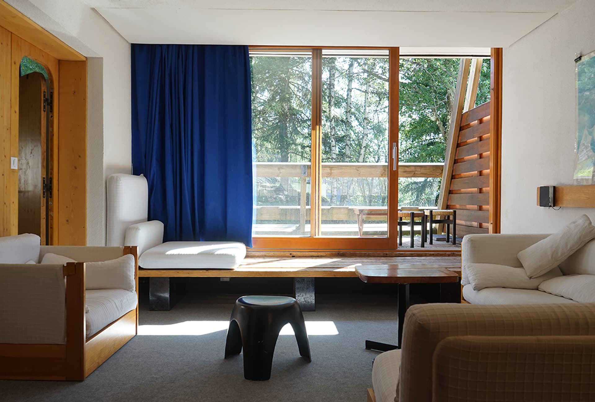 A picture of an empty room with blue curtains.