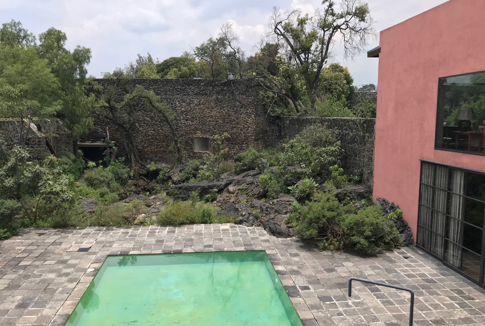 An image of a pool in a back yard.