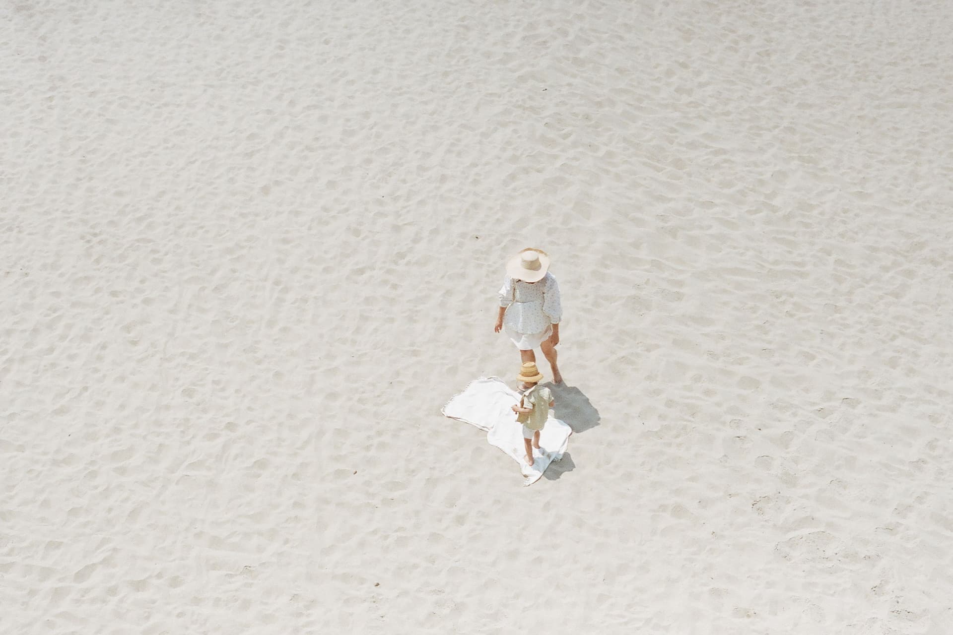 A woman stands on the beach.