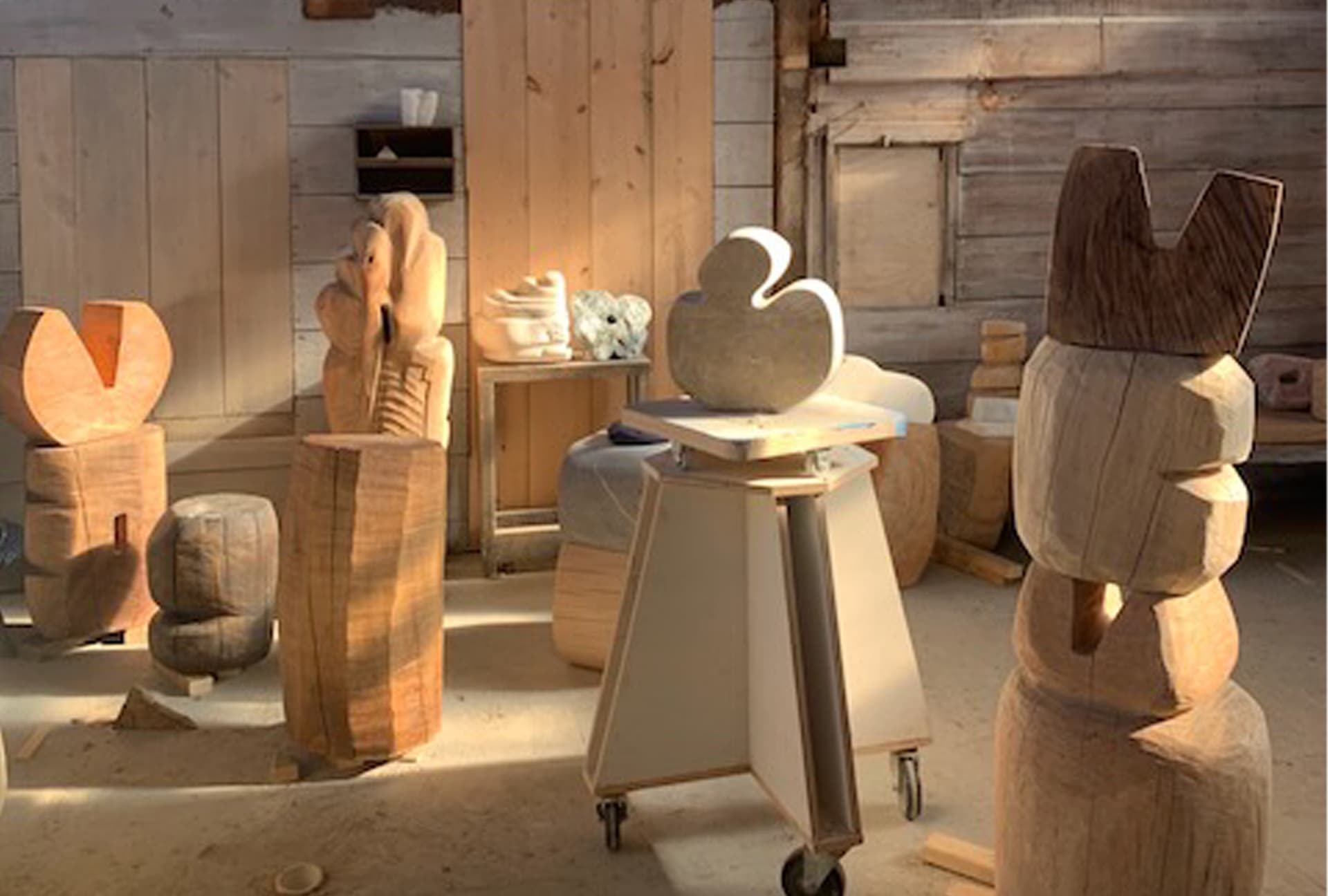 Wooden art figures inside of a wooden room.
